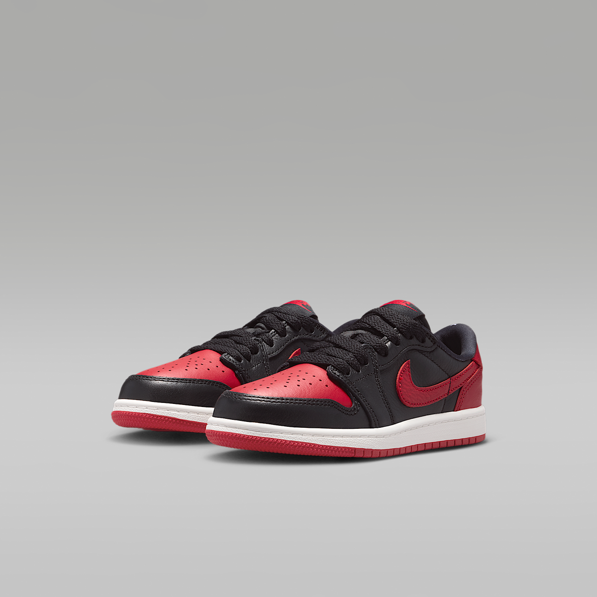 Jordan 1 Retro Low OG "Banned" Black Varsity Red Summit White Black Little Kids' - angled view of the pair